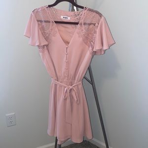 Pink mini dress with button detail on the front and crochet on the shoulders